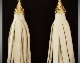 Cream and gold colored leather earrings