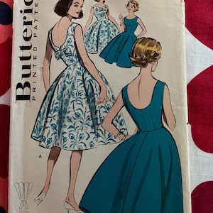 May include: Vintage Butterick printed patterns envelope featuring illustrations of dresses. The cover shows a woman in a teal dress and another in a floral print dress. The text includes "BUST 38", "SIZE 18", "9366", and "QUICK 'N EASY".