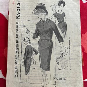 May include: Vintage sewing pattern titled "A Spadea Designer Pattern" featuring illustrations of a woman in a skirt suit and dress. The pattern is size 40 and includes the designer's name, David Goodstein, and the pattern number NA-2126.