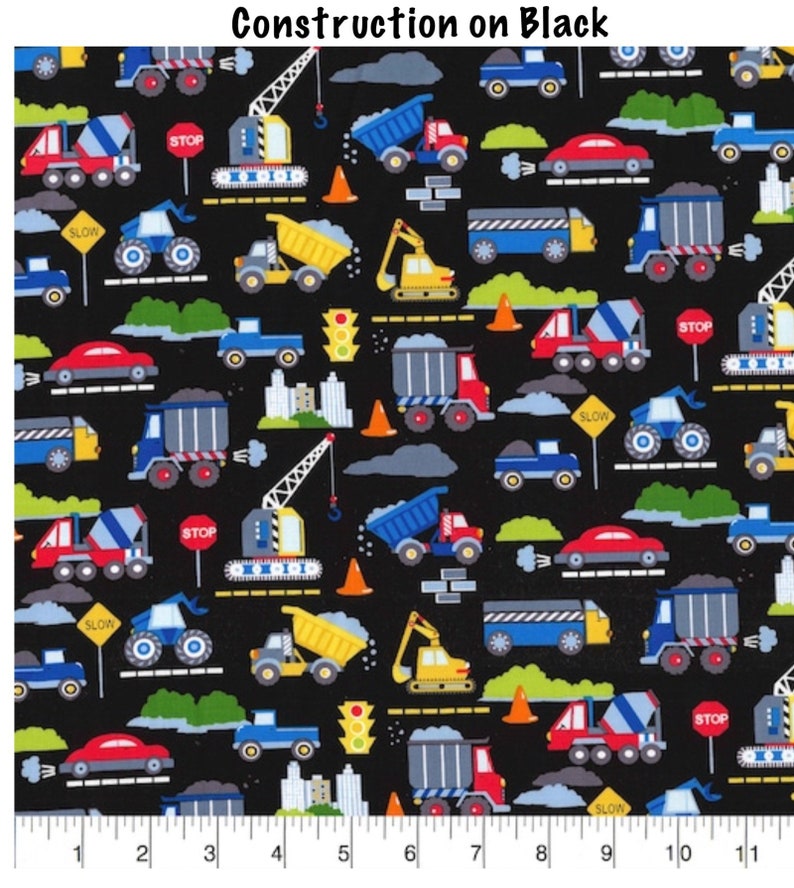 May include: A black fabric with a repeating pattern of construction vehicles, including dump trucks, cement mixers, excavators, cranes, and cars. The pattern also includes traffic signs, such as "STOP" and "SLOW", as well as traffic lights and cones.
