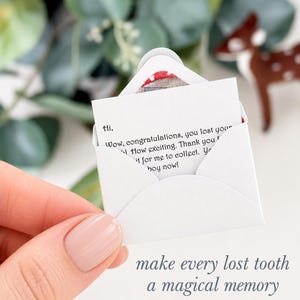 K&ouml;nnte beinhalten: Ein Miniatur-Briefumschlag aus wei&szlig;em Papier mit einer kleinen Notiz, auf der gedruckter Text steht: Hi, Wow, congratulations, you lost your tooth! How exciting. Thank you for leaving it for me to collect. You are a big boy now! Der Umschlag ist offen.