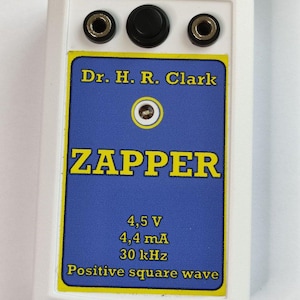 May include: A white rectangular device with a blue and yellow label that reads "ZAPPER" and "Dr. H. R. Clark." The label also includes technical specifications: 4.5 V, 4.4 mA, and 30 kHz. The device has three circular openings at the top.