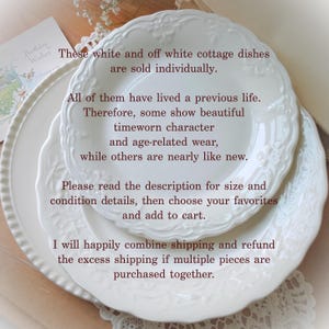 May include: A stack of white ceramic plates featuring embossed floral patterns along the scalloped edges. The text on the image reads: These white and off white cottage dishes are sold individually. All of them have lived a previous life.