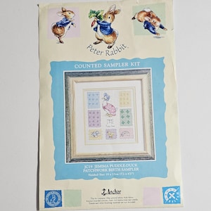May include: A counted sampler kit featuring Peter Rabbit illustrations. The kit includes a framed patchwork birth sampler with a duck design. The finished size is 7.5 x 6.7 inches. The kit includes Anchor stranded cotton and instructions.