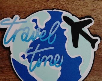 May include: A blue and white paper craft of the Earth with a black airplane flying over it. The words "travel time" are written in blue and white on the Earth.