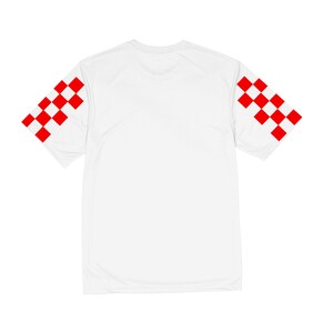 Puede incluir: Camiseta blanca con estampado de cuadros rojos y blancos en las mangas.