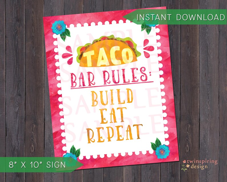 May include: A pink and white printable sign with a watercolor design featuring a taco and the text "Taco Bar Rules: Build Eat Repeat". The sign is 8 inches by 10 inches.
