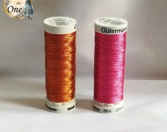 May include: Two spools of metallic thread, one orange and one pink. The spools are labelled "Gütermann" and have a length of 220 yards (200 metres).