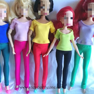 May include: Five dolls wearing different colored tops and leggings. The dolls are wearing a pink, yellow, green, blue, and purple top. The leggings are pink, red, black, teal, and green.