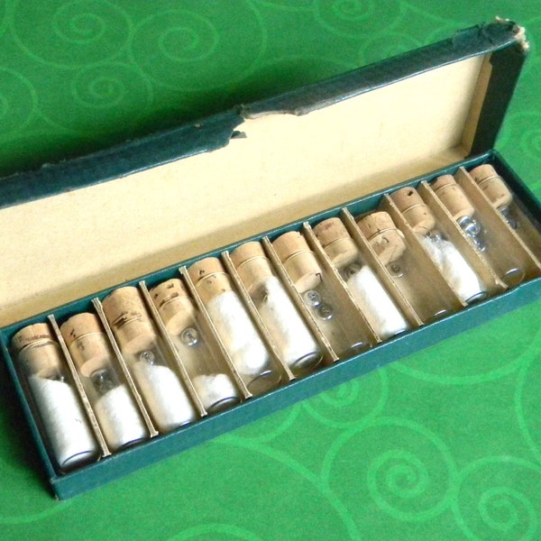 Curious Vintage Case of Watch Crowns for Repair. 12 Individual Glass Vials w/Cork Stoppers. Most Contain Crowns. Maker & Age Unknown.