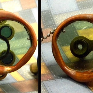 May include: A pair of steampunk goggles with brown leather frames and green tinted lenses. The goggles have a brass frame and a black strap.