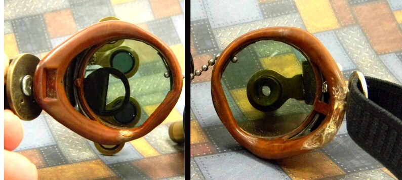 May include: A pair of steampunk goggles with brown leather frames and green tinted lenses. The goggles have a brass frame and a black strap.