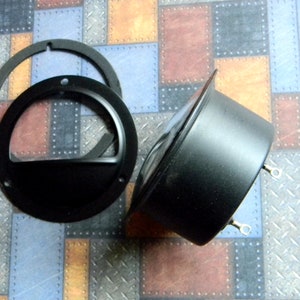 Puede incluir: Rejilla de altavoz de metal negro con dos soportes de montaje. La rejilla est&aacute; hecha de dos piezas, un anillo exterior m&aacute;s grande y un anillo interior m&aacute;s peque&ntilde;o.
