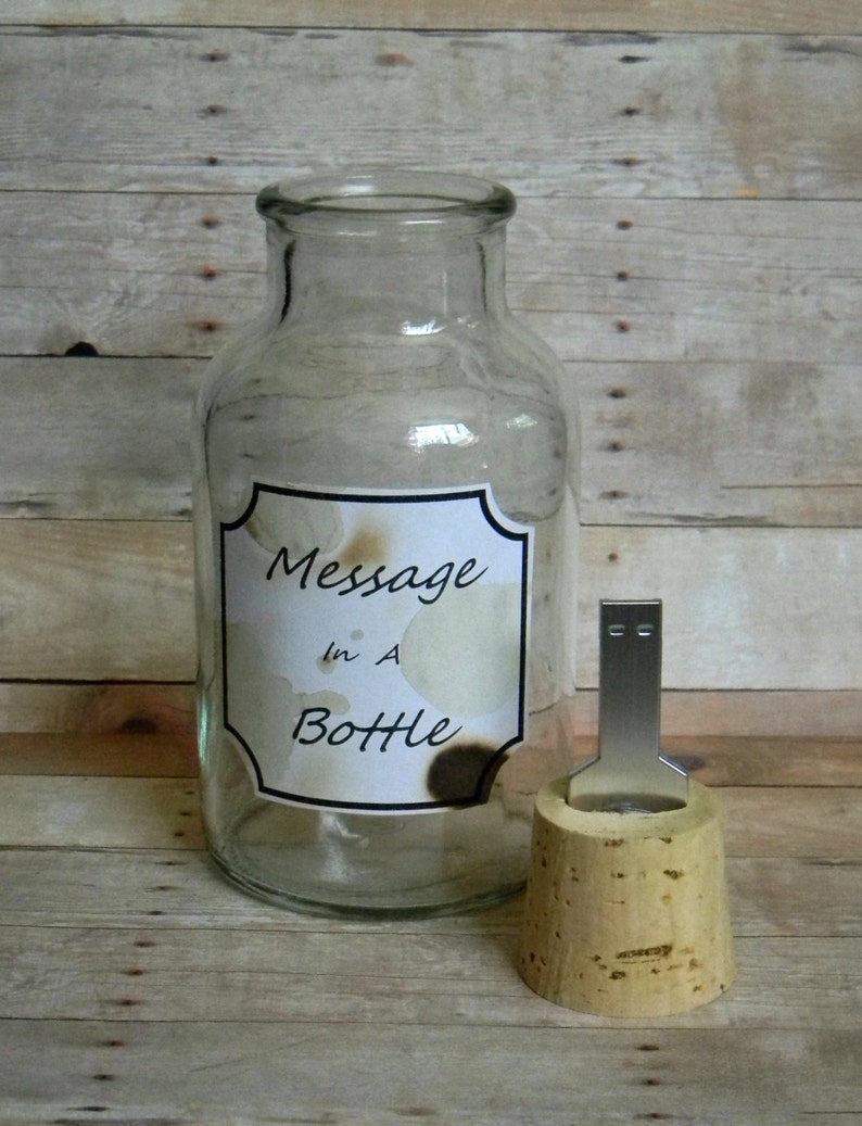 May include: A clear glass bottle with a cork stopper. The bottle has a label that says "Message in a Bottle".