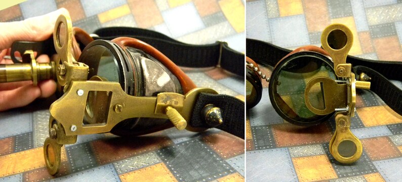 May include: A pair of steampunk goggles with brass accents and a black leather strap. The goggles have a magnifying lens on one side and a small telescope on the other.