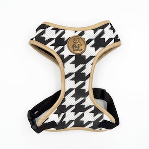 May include: Black and white houndstooth dog harness with gold trim and a small gold logo that says "Pawsitive Vibes".