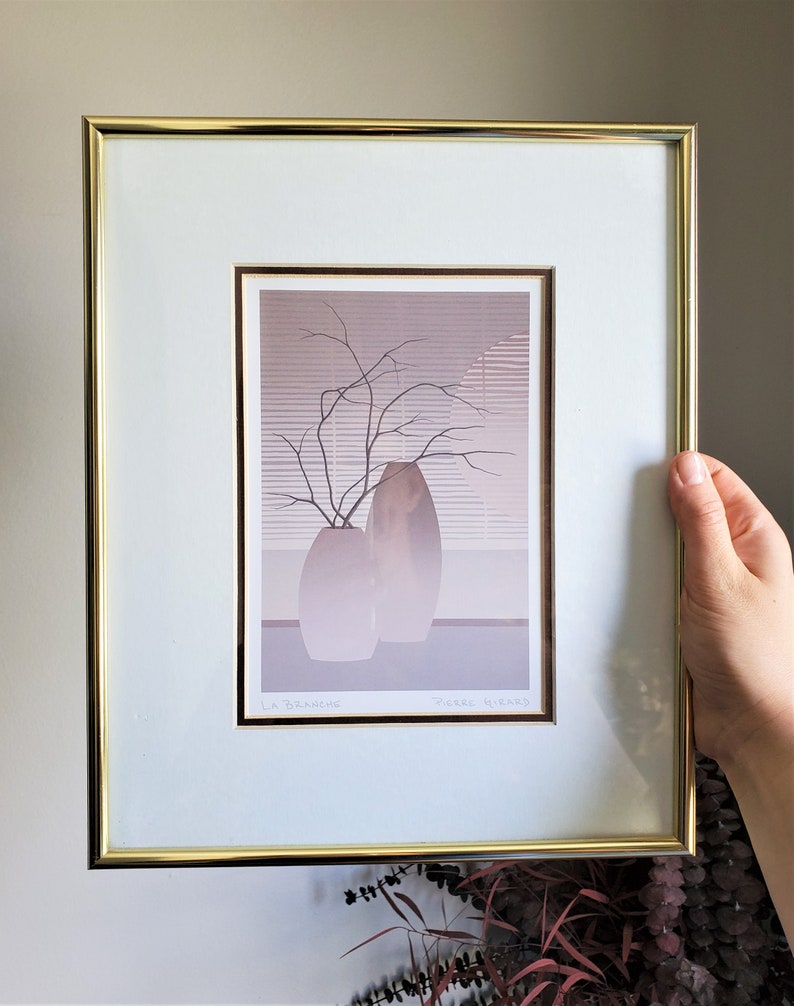 May include: A framed print of a still life featuring two vases with a branch of bare twigs in one of them. The print is in shades of gray and brown and has the text "La Branchie" and "Pierre Hirard" at the bottom.