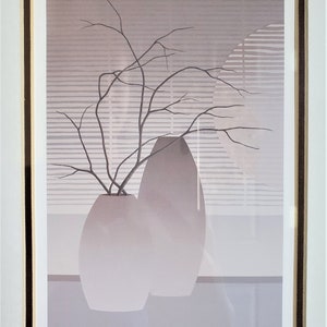 May include: A framed print of a minimalist still life featuring two gray ceramic vases with a branch of bare twigs in the smaller vase. The background is a light gray with a pattern of horizontal lines. The print is signed "LA BRANCHE" and "PIERRE GIRARD".