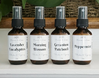 May include: Four amber glass spray bottles with black nozzles, each containing 2 oz of room and linen spray. The white labels feature the brand name Soap Roots, the text Room & Linen, Shake & Spray, and scents: Lavender Eucalyptus, Morning Blossom, Geranium Patchouli, and Peppermint.