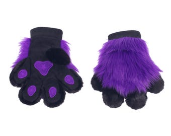 May include: A pair of black and purple furry paw gloves. The gloves have black palms with purple paw pads and a purple star design. The cuffs and fur are purple. The gloves are designed to resemble animal paws.