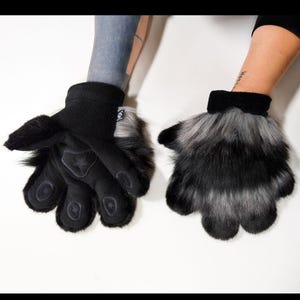 May include: A white ceramic mug with a black handle and the text "But First, Coffee" in a black, bold font. The mug is on a white surface.