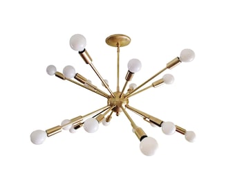 May include: A gold-toned, multi-light chandelier with a starburst design. The chandelier has 18 light bulbs and a central hub.