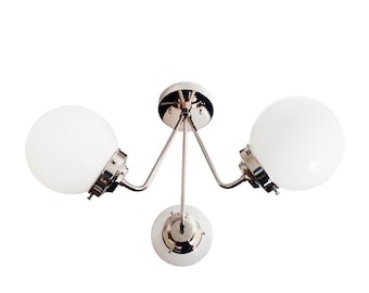 May include: A chrome ceiling light fixture with three white globe-shaped shades.