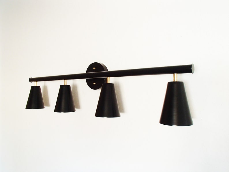 May include: A black four-light vanity light fixture with a long, straight bar and cone-shaped shades.