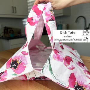 May include: A dish tote with a floral pattern of pink poppies on a white background. The tote has a light pink interior and handles. The text "Dish Tote" and "2 sizes" is visible, along with a sewing machine icon and the words "Sewing pattern and tutorial".