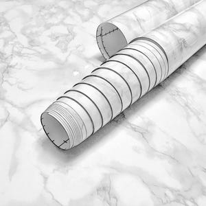 May include: A roll of white marble contact paper with a gray veining pattern. The paper is rolled up and the end is visible.