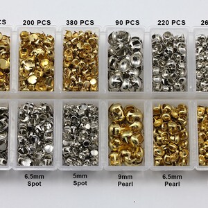 May include: A clear plastic organiser containing various metal embellishments. The embellishments include gold and silver spots and pearls in different sizes, with quantities ranging from 90 to 380 pieces. The sizes are 5mm, 6.5mm, and 9mm.