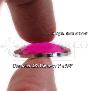 May include: A close-up of a bright pink, faceted, round, glass gem with a silver backing. The gem is 1 inch in diameter and 3/16 inch tall.  Height: 5mm or 3/16" Diameter: 25x18mm or 1"x3/4"