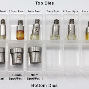 May include: A clear plastic organizer containing various metal dies for crafting. The top row includes 5mm, 6.5mm, and 9mm Pearl dies, and 5mm, 6.5mm, and 9mm Spot dies. The bottom row shows corresponding Spot/Pearl dies. Text on the image reads "Top Dies" and "Bottom Dies".