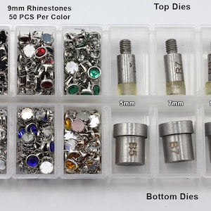 May include: A clear plastic organizer filled with various rhinestones in multiple colors, including black, red, green, and blue. The text "9mm Rhinestones" and "50 PCS Per Color" is visible. Also included are top and bottom dies for setting the rhinestones.
