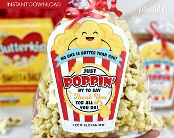 May include: A printable gift tag featuring a cartoon popcorn bucket with the text "No one is butter than you!" and "Just poppin' by to say thank you for all you do!"  The tag is red, yellow, and white with a blue ribbon.