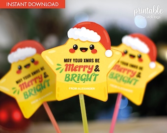 May include: Printable Christmas glow stick tags featuring a yellow star with a red Santa hat, smiling face, and the text "May your Xmas be Merry & Bright" with a green and red font. The tags are attached to glow sticks.