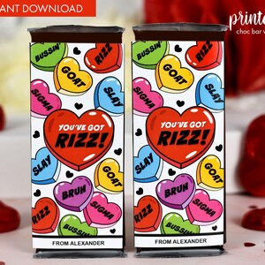 May include: Printable chocolate bar wrapper with a heart pattern and the text "You've got Rizz!" in red. The hearts have various slang words on them, including "goat", "slay", "bussin", "sigma", and "rizz".