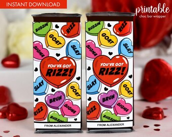 May include: Printable chocolate bar wrapper with a heart pattern and the text "You've got Rizz!" in red. The hearts have various slang words on them, including "goat", "slay", "bussin", "sigma", and "rizz".