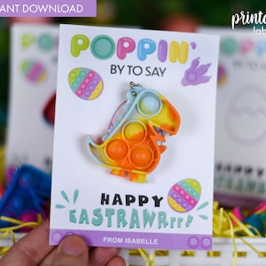 May include: A printable Easter gift tag with a colorful dinosaur pop-it toy. The tag says "Poppin' By To Say Happy Eastrawrrr!" and "From Isabelle".