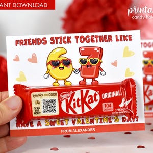 May include: A red Kit Kat candy bar is held in front of a Valentine's Day card. The card reads "FRIENDS STICK TOGETHER LIKE" and features cartoon numbers 6 and 7 wearing sunglasses. The card also says "HAVE A SWEET VALENTINE'S DAY!"