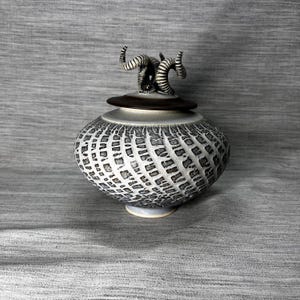 May include: A handmade, wooden serving tray with a natural finish. The tray features a rectangular shape with rounded corners and two carved handles. The wood grain is visible, adding to its rustic charm. Perfect for serving food or displaying items.