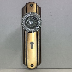 May include: A set of three ceramic mugs with a speckled, matte finish. The mugs are in shades of cream, light gray, and dark gray. Each mug has a simple, minimalist design and a rounded handle.