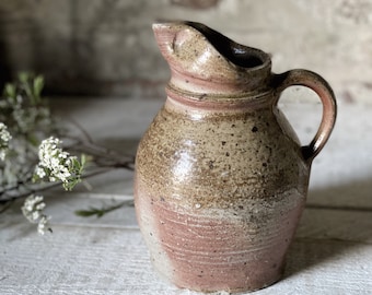 A beautiful antique pottery French water jug or pitcher