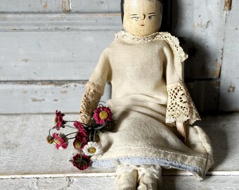 A lovely antique wooden Grodnertal penny doll or peg doll In original clothing