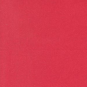 May include: Bright red fabric showcasing a detailed paisley design. The pattern includes swirling, teardrop-shaped motifs and floral elements, creating a textured surface. Suitable for various crafting and sewing projects. The fabric is a rich, bold colour.