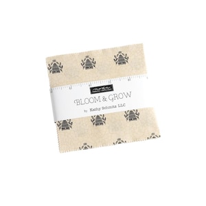 May include: A beige fabric square with a black and white beehive pattern. The fabric is labeled "Bloom & Grow by Kathy Schmitz LLC".