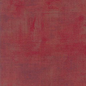 Może przedstawiać: Teksturowane, abstrakcyjne tło w odcieniach czerwieni i brązu. Powierzchnia ma postarzany wygląd z widocznymi pociągnięciami pędzla i efektem nakrapiania, tworząc estetykę vintage lub artystyczną. Paleta kolorów zdominowana jest przez głębokie czerwienie.