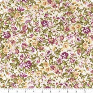 May include: A fabric featuring a dense floral pattern with magenta, yellow, and cream blossoms intertwined with olive green leaves and vines on a white background, shown with a ruler measuring up to 10 inches along the bottom edge.