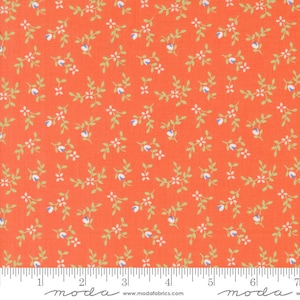 May include: A vibrant orange fabric featuring a repeating pattern of small light green leafy vines with tiny white flowers and blue accents. A white ruler is visible at the bottom edge, showing measurements in inches up to 7 inches.