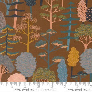 May include: A brown fabric featuring a repeating pattern of stylized trees in shades of teal, peach, yellow, and light blue. A white ruler is visible at the bottom, showing a scale of 7 inches for the width of the printed textile design.